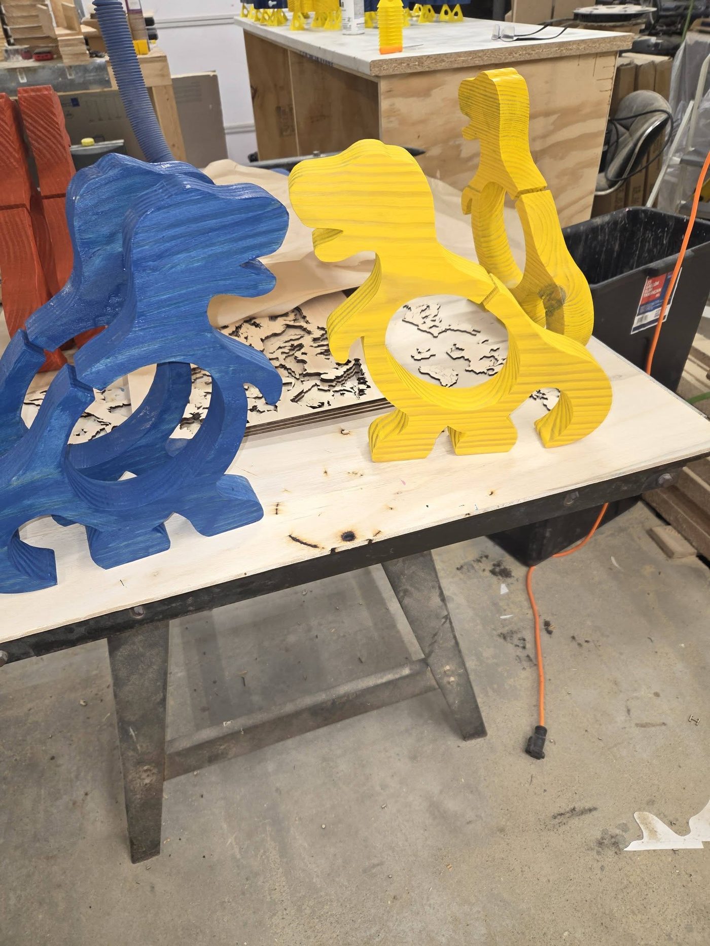 Wooden dinosaur coin banks in blue and yellow finishes